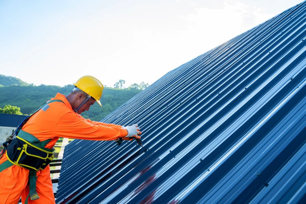 a worker installing a metal roof