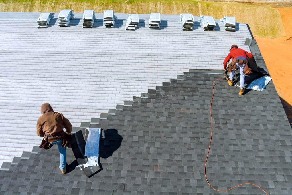 two men installing a roof